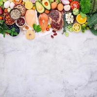 Ingredients for healthy foods selection set up on white concrete photo