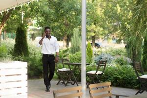 happy african american with a phone on the street photo