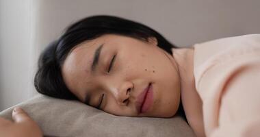 Thai Woman Laying in Bed Looking at Camera video