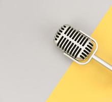 Retro microphone with copy space on color background photo