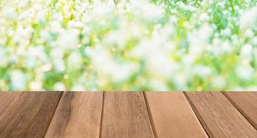 Empty Wooden texture on blurred green grass background photo