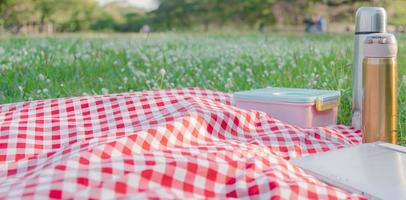 Red checkered tablecloth texture with accessories photo