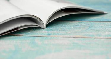 Stack magazines on wooden table photo