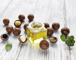 Natural macadamia oil and Macadamia nuts photo