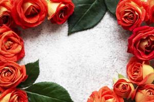 Flowers composition. Frame made of red  roses and leaves photo