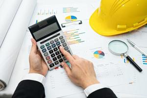 Architect or engineer working project accounting with graph photo