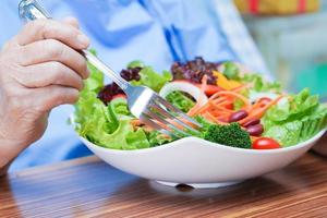 Asian senior woman patient eating breakfast photo