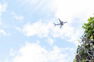 plane flying at low altitude in a cloud sky and cleared photo