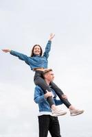 Young loving couple spending time together in the park having fun photo