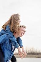 Young loving couple spending time together in the park having fun photo