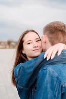 Young loving couple embracing each other outdoors in the park photo