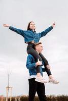 Young loving couple spending time together in the park having fun photo