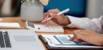 Accountant using a calculator to calculate the number photo