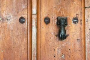 classic antique metal doorknocker with hand shape photo