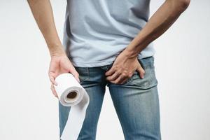 Man holding his bottom and tissue paper because Diarrhea. photo