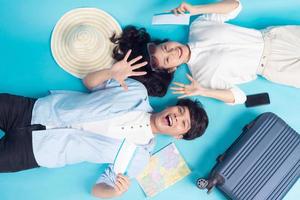 Young couple preparing to travel over blue background photo