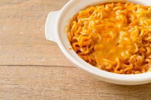 Spicy instant noodle bowl with mozzarella cheese photo