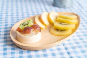 Pudding fruits with kiwi and apple on table photo