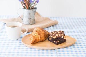 Croissant and brownies on table photo