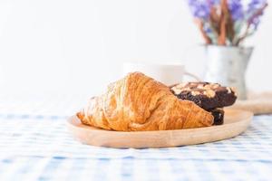 Croissant and brownies on table photo