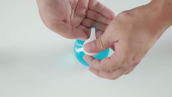 A man is cleaning his hands and fingers with an alcohol gel. video