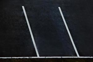 Empty parking. White markings for cars on black asphalt. photo