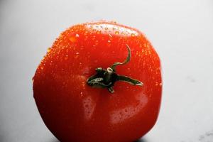 Fresh tomatoes with drops of water. Farm vegetables for vegan diet. photo