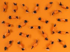 Halloween holiday flat lay from orange and black candies. photo