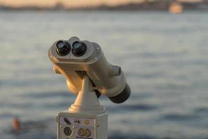 Binoculars for tourists on the background of the sea photo