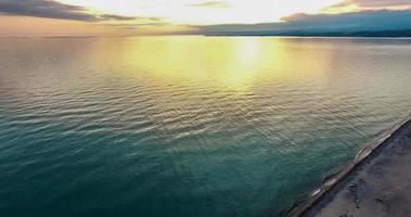 sunset over water surface of the sea from the height of bird flight photo