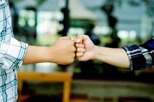 Two fists teamwork unity Close-up of two hands showing photo