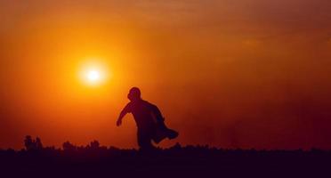 running superhero silhouette moving forward with determination photo