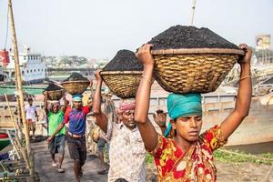 Amen Bazar, Dhaka, Bangladesh, 2018 - Men and women working hard for earning money. photo