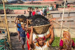 Amen Bazar, Dhaka, Bangladesh, 2018 - Men and women working hard for earning money. photo