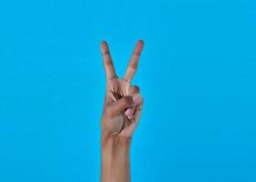 human hand showing victory, peace sign or number 2 with fingers. photo