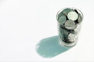 coins in glass. white background photo