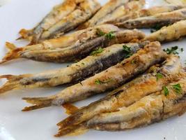 fresh fried sardines with herbs and spices photo