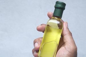 hand holding a bottle of olive oil photo