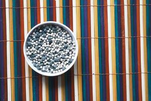 mixed pepper in a bowl on table , top view photo