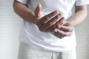 man suffering pain in hand close up photo