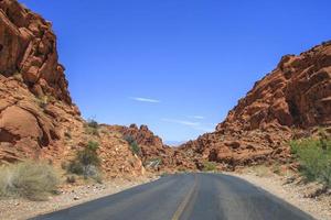 Road going through the middle of a canyon desert photo