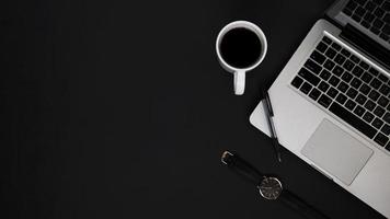 Top view workspace with laptop pen watch and coffee cup photo