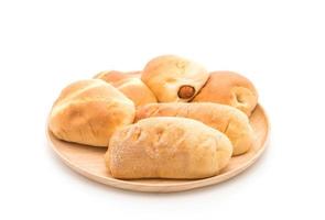 Bread in wood plate on white background photo