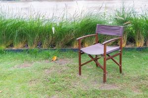 Empty chair on grass in park - with sunflare processing style photo