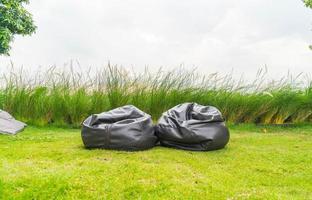 Empty chair bag on grass in park photo