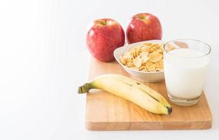 Milk, apple, banana and cornflakes for breakfast photo