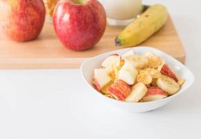 Milk, apple, banana and cornflakes for breakfast photo