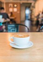 Hot caramel macchiato in coffee shop photo