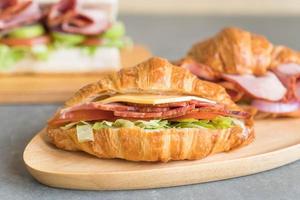 Croissant sandwich ham on table photo