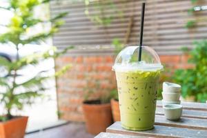 Iced green tea milkshake on table photo